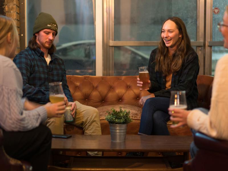 side room with people enjoying beers